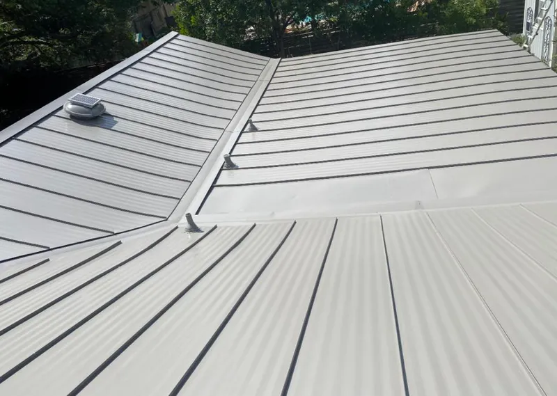Solar attic fan installed on a metal roof for Roof Ventilation in Ocean Pointe